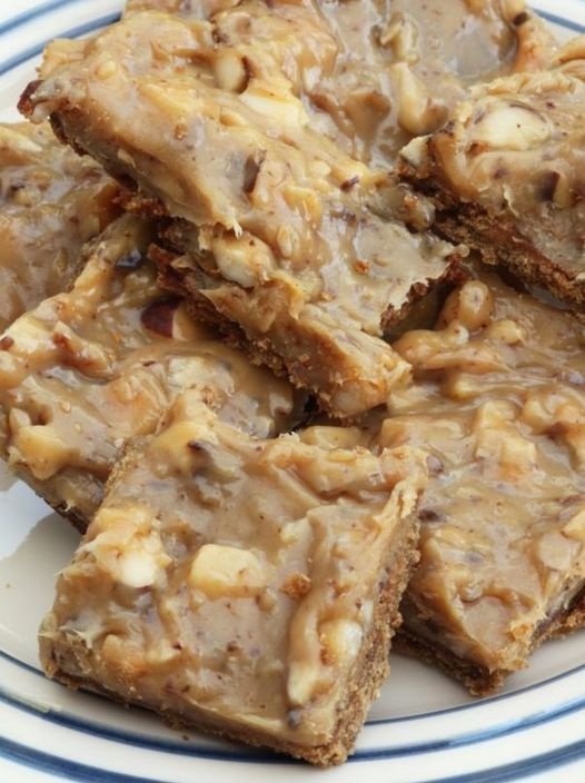 Caramel, Bisicuit And Nut Squares On A Blue Striped Plate